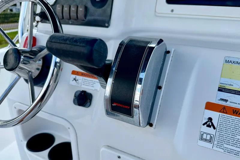 Slide: The Image of Close-up of 2003 Seaswirl Striper 2101 CC boat controls and steering wheel. - 17