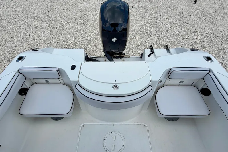 Slide: The Image of 2003 Seaswirl Striper 2101 CC boat interior with seating and motor view. - 19