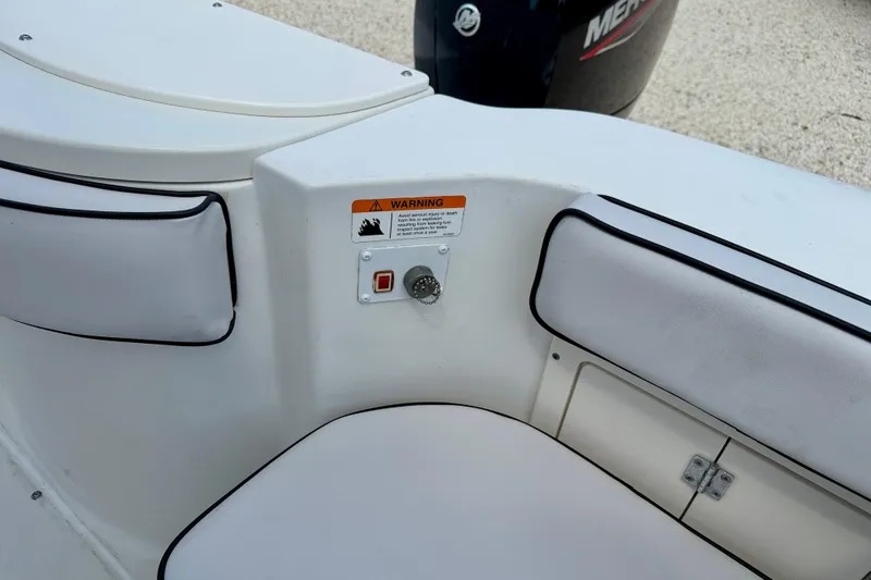 Slide: The Image of 2003 Seaswirl Striper 2101 CC boat interior with warning label and seating. - 22