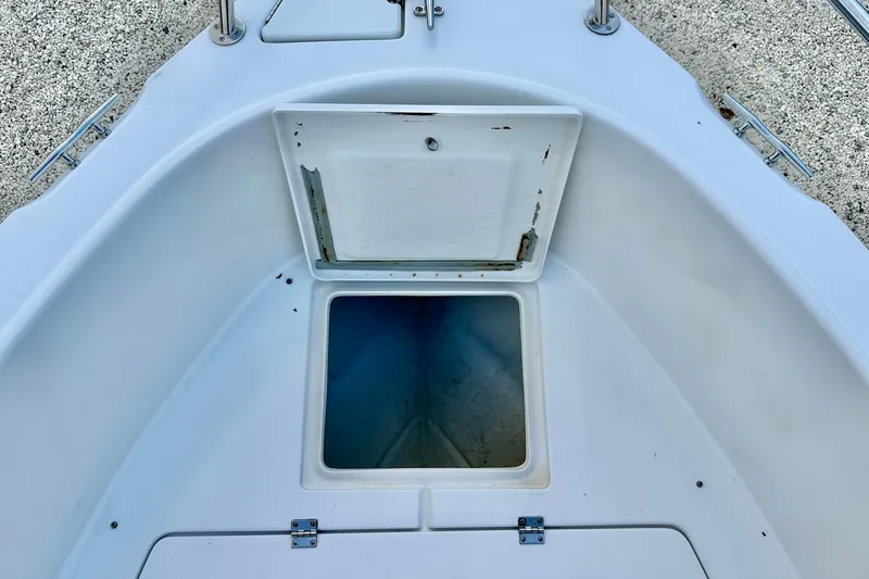 Slide: The Image of Open storage compartment on a 2003 Seaswirl Striper 2101 CC boat deck. - 25