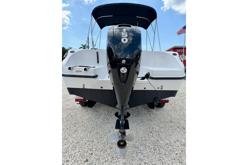 Slide: The Image of 2003 Seaswirl Striper 2101 CC boat with 150 HP outboard motor, parked on gravel. - 28