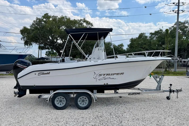 Slide: The Image of 2003 Seaswirl Striper 2101 CC boat on trailer, side view, outdoors. - 4