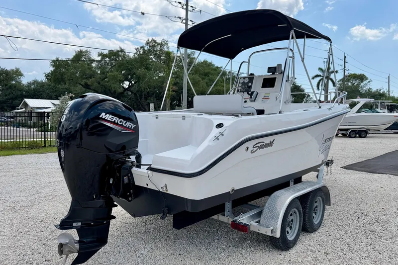 Slide: The Image of 2003 Seaswirl Striper 2101 CC boat with Mercury outboard engine on a trailer. - 5