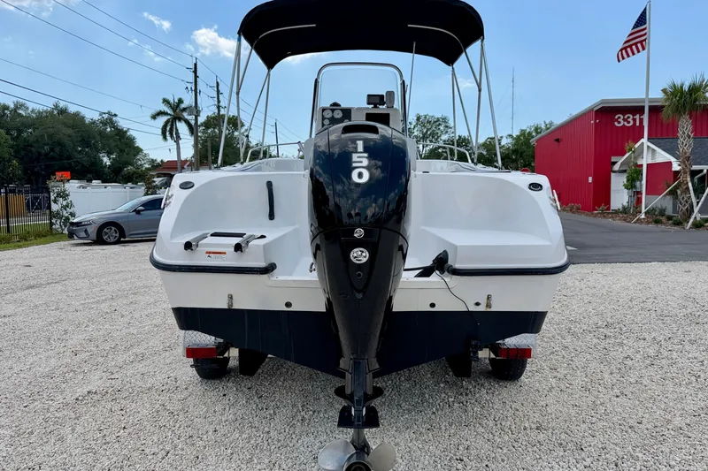 Slide: The Image of 2003 Seaswirl Striper 2101 CC boat with 150 HP engine, parked outdoors. - 6