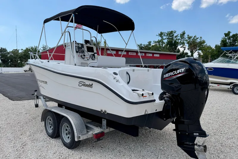 Slide: The Image of 2003 Seaswirl Striper 2101 CC boat with Mercury outboard motor on trailer. - 7