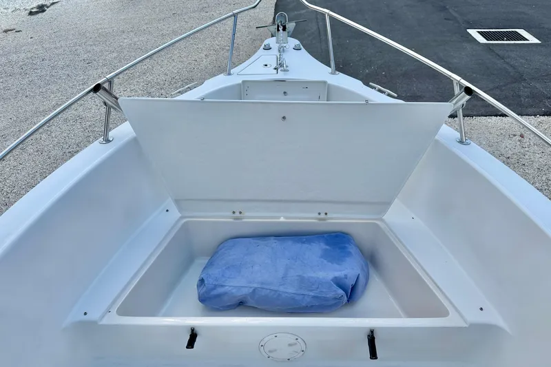 Slide: The Image of 2003 Seaswirl Striper 2101 CC boat storage compartment with blue cushion. - 9