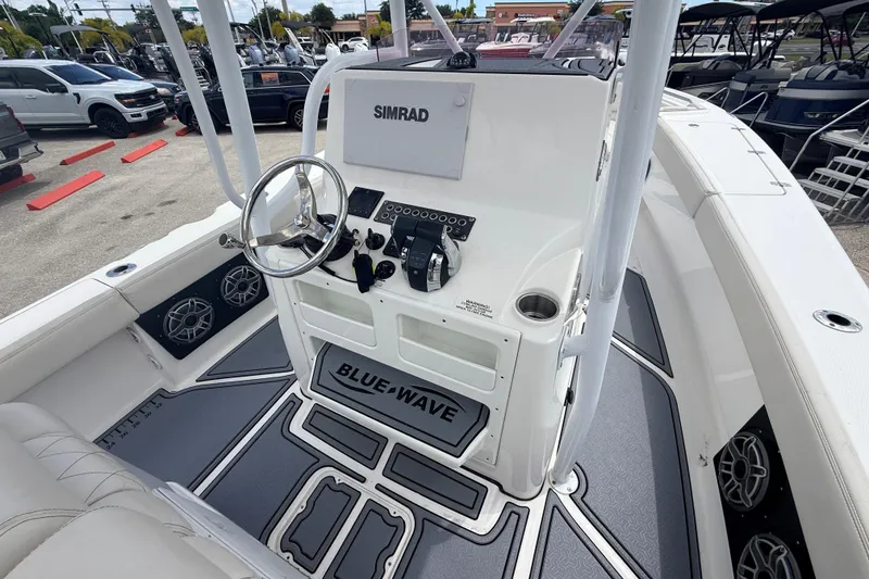 Slide: The Image of 2021 Blue Wave 2800 Makaira boat interior with steering console and Simrad electronics. - 10