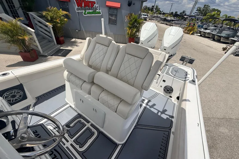 Slide: The Image of 2021 Blue Wave 2800 Makaira boat interior with dual seats and steering wheel. - 14