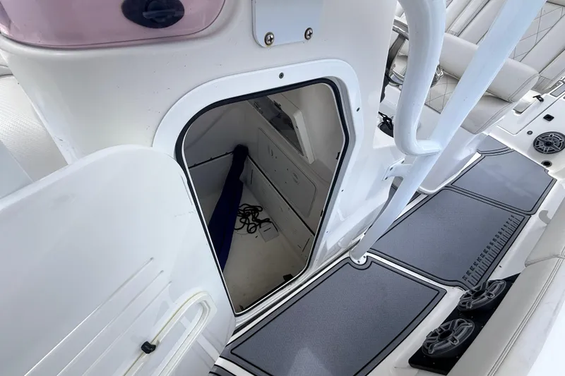 Slide: The Image of 2021 Blue Wave 2800 Makaira boat interior with open storage compartment and seating area. - 18