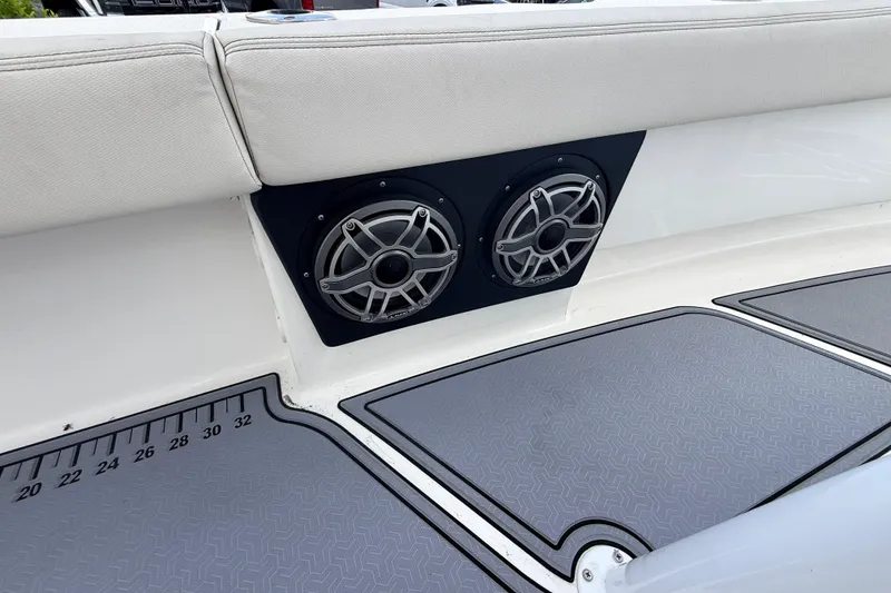 Slide: The Image of 2021 Blue Wave 2800 Makaira boat interior with dual speakers and cushioned seating. - 19