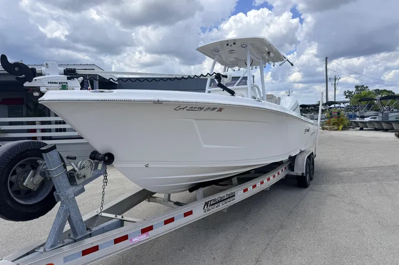 Slide: The Image of 2021 Blue Wave 2800 Makaira boat on trailer under cloudy sky. - 3