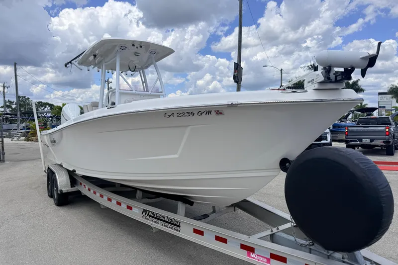 Slide: The Image of 2021 Blue Wave 2800 Makaira boat on trailer under cloudy sky. - 5