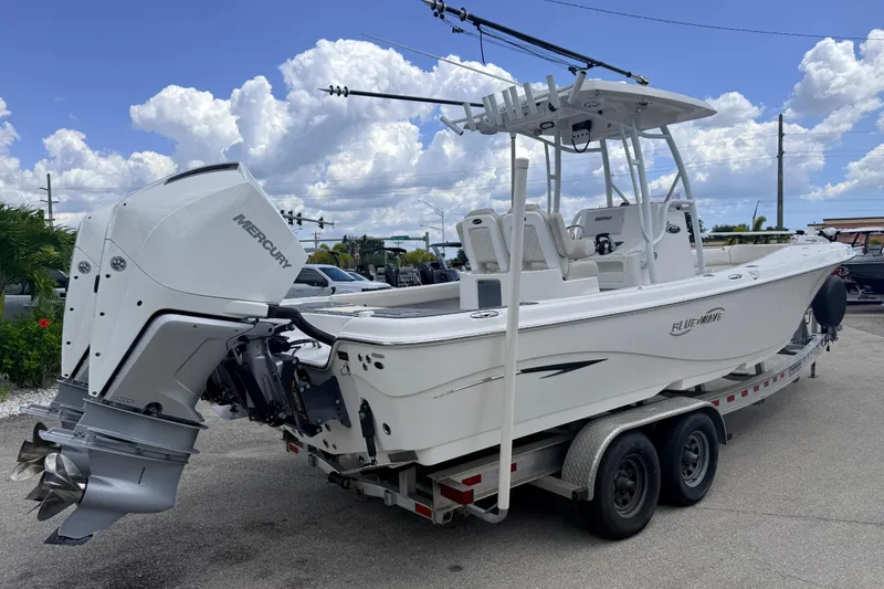 Slide: The Image of 2021 Blue Wave 2800 Makaira boat on trailer, featuring Mercury outboard engine. - 6