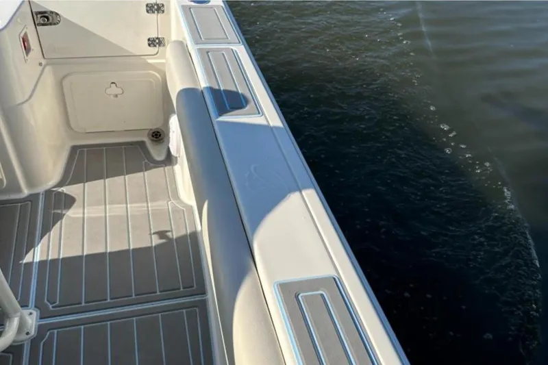 Slide: The Image of 2023 Sailfish 220 CC boat interior with water view, featuring sleek design and modern finishes. - 11