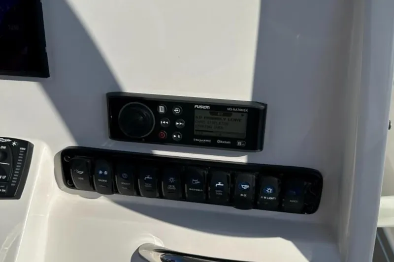 Slide: The Image of 2023 Sailfish 220 CC boat dashboard with Fusion stereo and control panel. - 17
