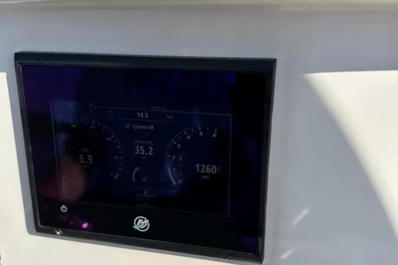Slide: The Image of Dashboard display of 2023 Sailfish 220 CC boat showing system status and fuel levels. - 18
