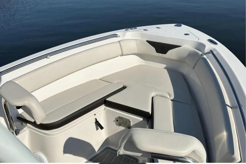 Slide: The Image of 2023 Sailfish 220 CC boat interior with cushioned seating and sleek design. - 4