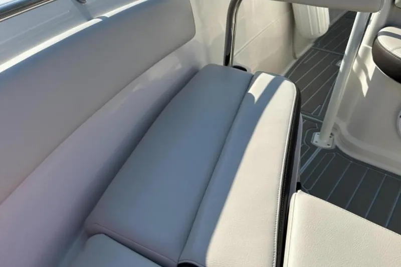 Slide: The Image of 2023 Sailfish 220 CC boat interior with cushioned seating and sleek design. - 7