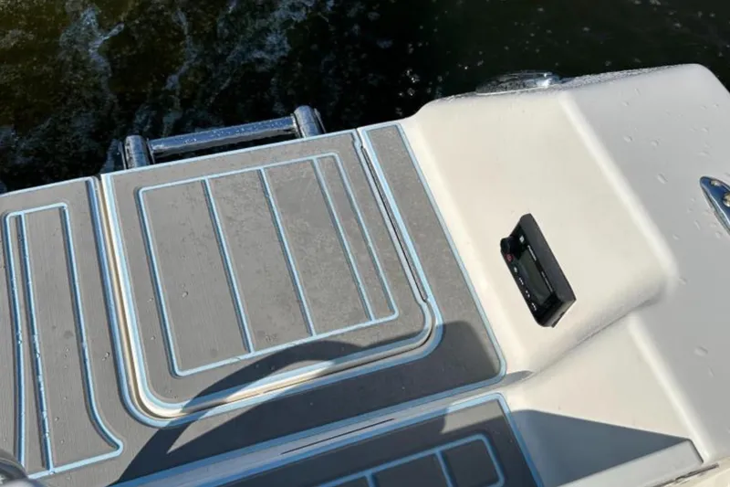 Slide: The Image of 2023 Sailfish 220 CC boat deck with non-slip surface and water droplets. - 9
