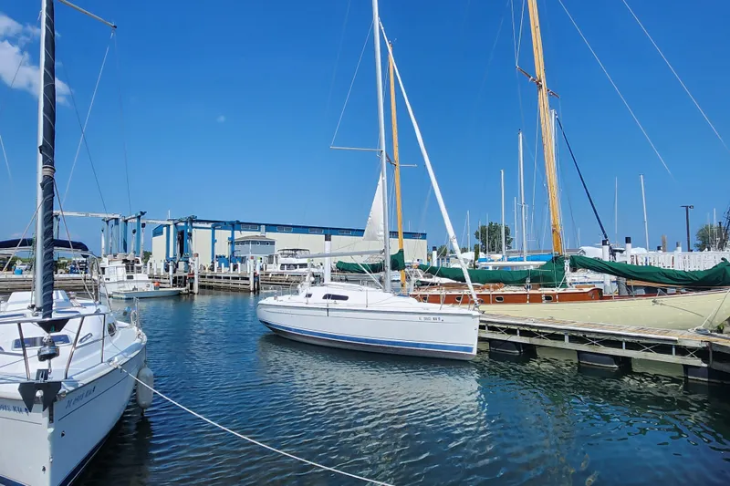 The Image of Sailboats docked at marina, featuring a 2005 Hunter 27 under clear blue skies. - 0