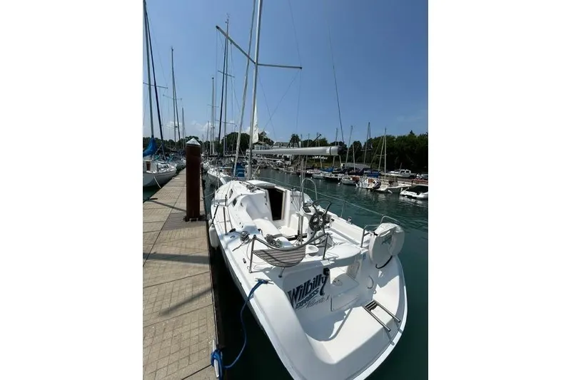 Slide: The Image of 2005 Hunter 27 sailboat docked at marina under clear blue sky. - 10