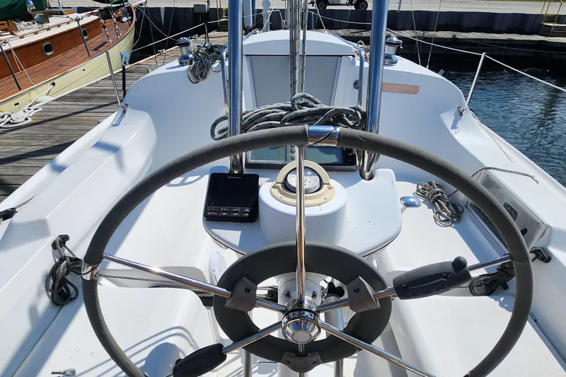 Slide: The Image of Steering wheel and cockpit of a 2005 Hunter 27 sailboat at a marina. - 11