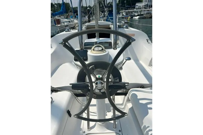 Slide: The Image of Steering wheel of a 2005 Hunter 27 sailboat in a marina setting. - 14