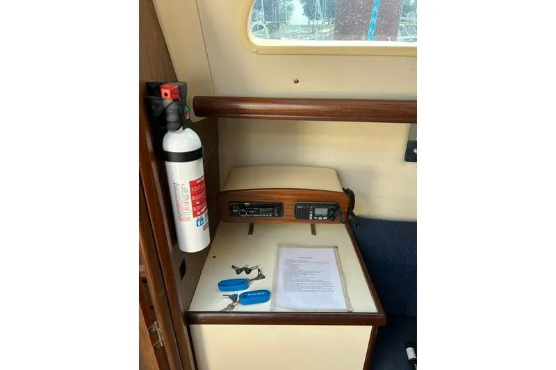 Slide: The Image of Interior of 2005 Hunter 27 sailboat with fire extinguisher and navigation equipment. - 22