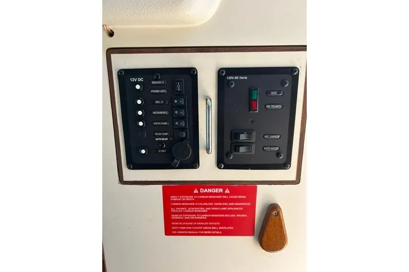Slide: The Image of Electrical control panel on a 2005 Hunter 27 boat, featuring 12V DC and 120V AC systems. - 23