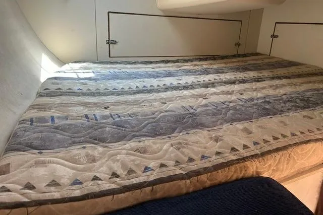 Slide: The Image of Interior cabin of a 2005 Hunter 27 sailboat with a patterned mattress. - 29