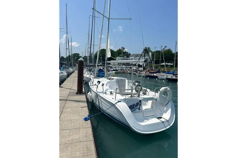 Slide: The Image of 2005 Hunter 27 sailboat docked at marina, clear sky, calm water. - 3