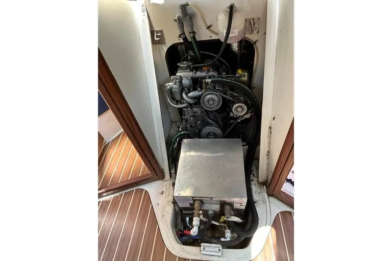 Slide: The Image of Engine compartment of a 2005 Hunter 27 sailboat, showcasing mechanical components. - 33