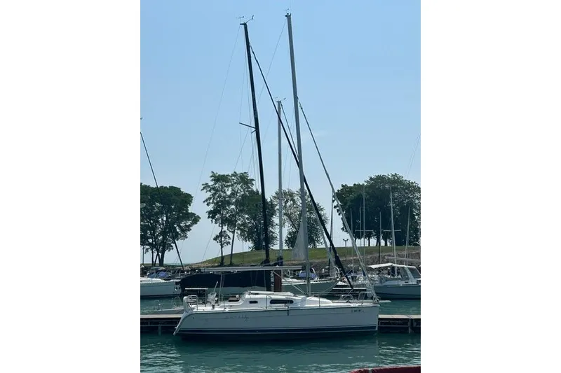 Slide: The Image of Sailboat docked at marina, Hunter 27 model, 2005, with trees in the background. - 5
