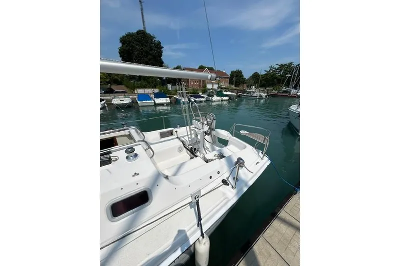 Slide: The Image of Hunter 27 sailboat from 2005 docked in a marina under a clear blue sky. - 8