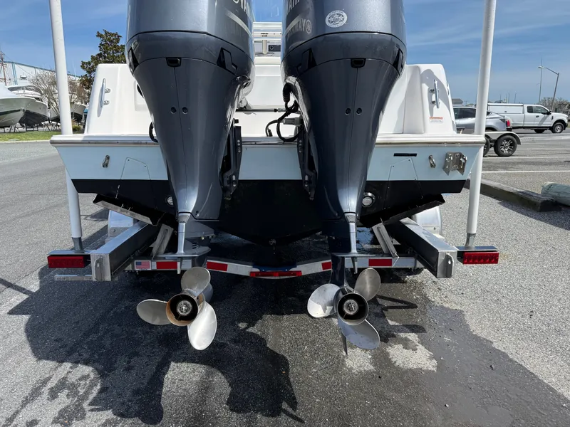 Slide: The Image of Rear view of 2021 Contender 25 Tournament boat with dual outboard motors. - 27
