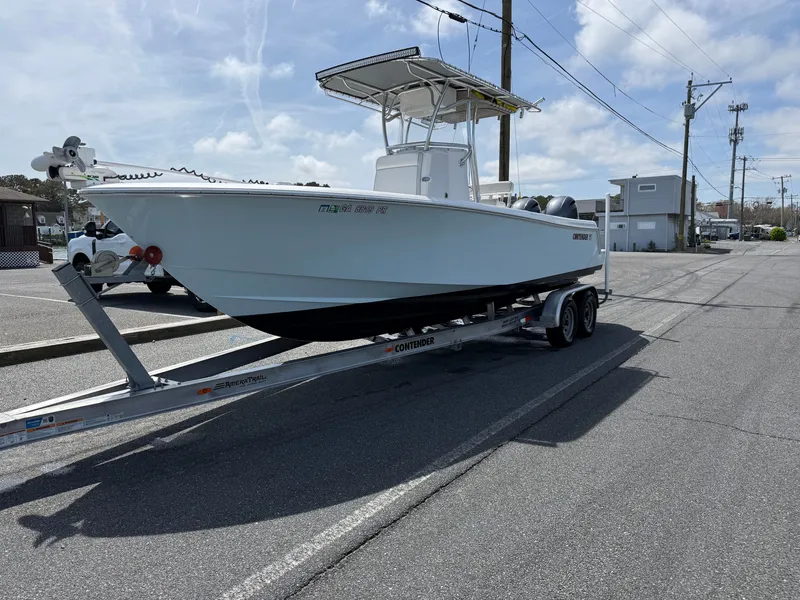 Slide: The Image of 2021 Contender 25 Tournament boat on trailer, sunny day. - 32