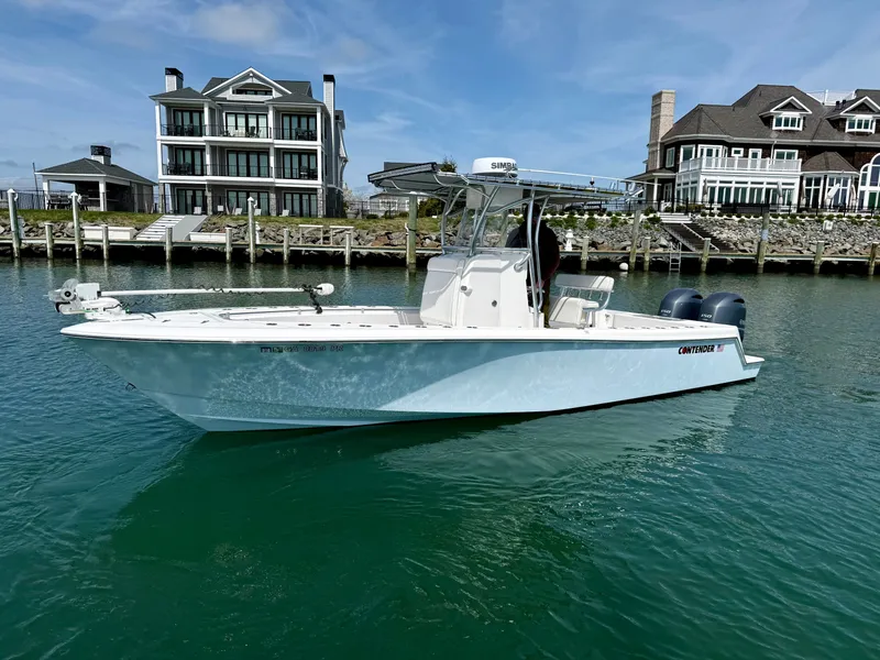Slide: The Image of 2021 Contender 25 Tournament boat near waterfront homes. - 4