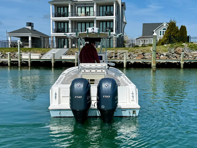 Slide: The Image of Contender 25 Tournament 2021 boat docked in front of a house. - 5