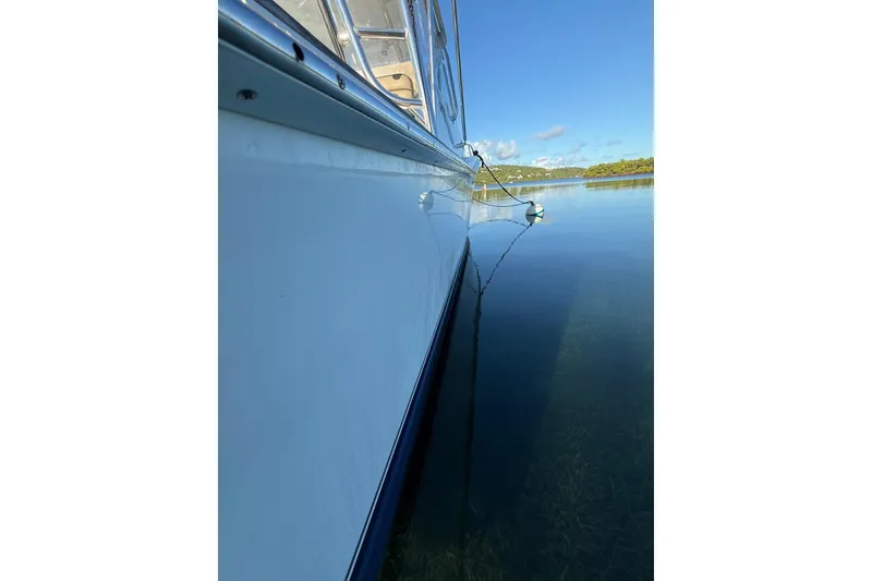 Slide: The Image of Side view of a 2003 Cabo 35 Express boat on calm water. - 11