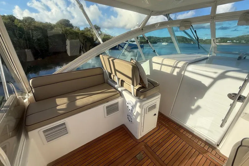 Slide: The Image of Interior of 2003 Cabo 35 Express boat with cushioned seating and wooden flooring. - 12
