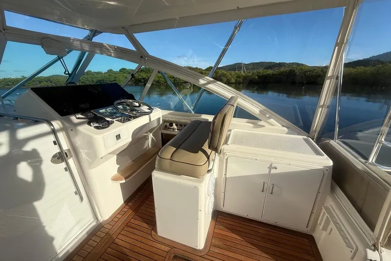 Slide: The Image of 2003 Cabo 35 Express boat helm with scenic water view. - 13