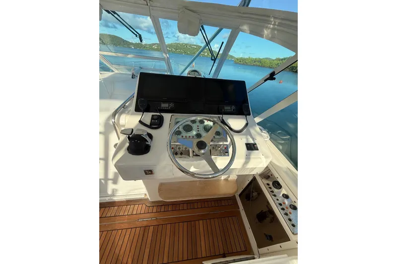 Slide: The Image of Helm of 2003 Cabo 35 Express boat with steering wheel and navigation equipment. - 14