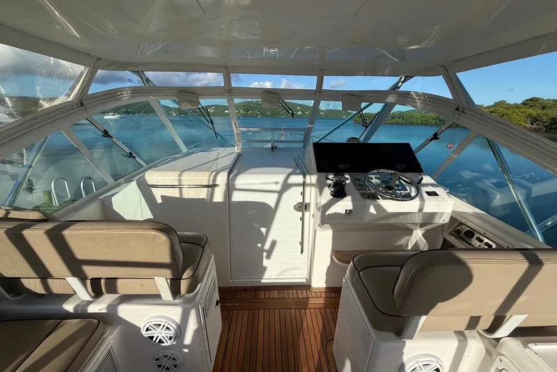 Slide: The Image of Interior view of 2003 Cabo 35 Express boat with helm and seating. - 15