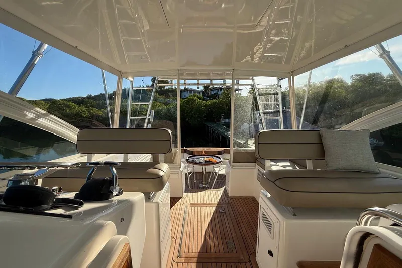 Slide: The Image of Interior view of 2003 Cabo 35 Express yacht with seating and wooden flooring. - 18
