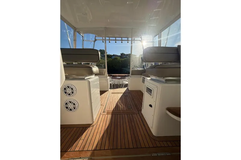 Slide: The Image of Interior view of 2003 Cabo 35 Express boat with wooden flooring and cushioned seating. - 19