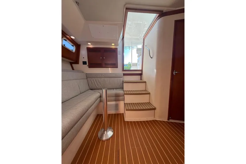 Slide: The Image of Interior of 2003 Cabo 35 Express yacht with stairs and seating area. - 23