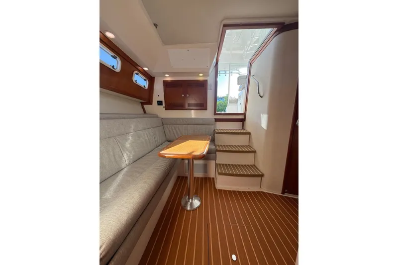 Slide: The Image of Interior of 2003 Cabo 35 Express yacht with seating and wooden flooring. - 24