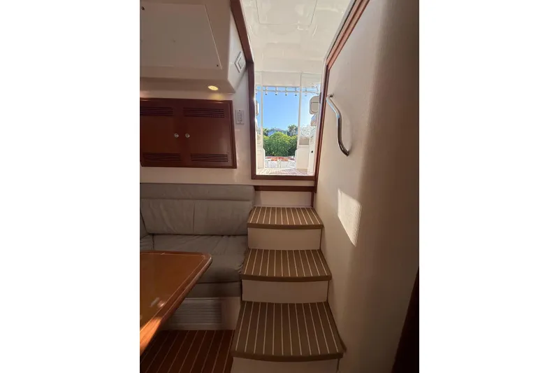 Slide: The Image of Interior view of 2003 Cabo 35 Express yacht, featuring stairs and seating area. - 25