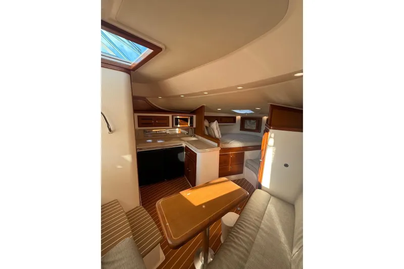 Slide: The Image of Interior of 2003 Cabo 35 Express yacht with cozy seating and kitchenette. - 29