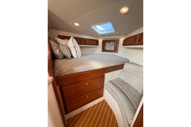 Slide: The Image of Cozy cabin interior of 2003 Cabo 35 Express with bed, seating, and wooden storage. - 31